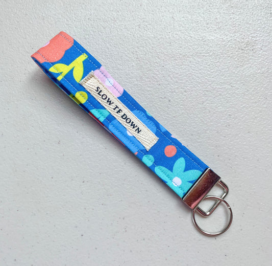 Slow tf down wristlet keychain